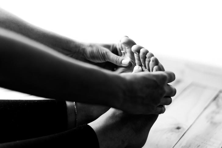 hands stretching feet