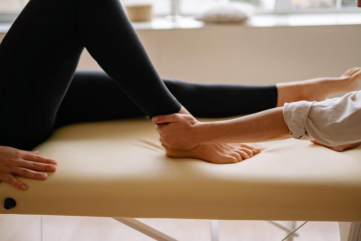 person massaging someone's foot